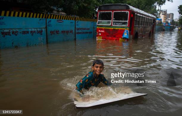 Child enjoy in the waterlogged road due to heavy rain on S.V. Road, at Khar on July 5, 2022 in Mumbai, India. Mumbai has been witnessing heavy rain...