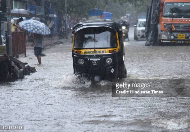 Vehicles wade through waterlogged road due to heavy rain on Nagardas Road, near Andheri Subway, at Andheri on July 5, 2022 in Mumbai, India. Mumbai...