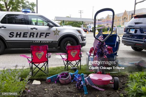 Chairs and scooters left behind at the scene of a mass shooting on the Fourth of July parade route Monday, July 4 in Highland Park.