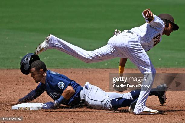 Julio Rodriguez of the Seattle Mariners steals second base ahead of the tag of Jake Cronenworth of the San Diego Padres during the third inning of a...