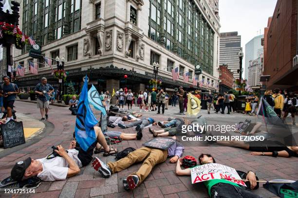 Members of Extinction Rebellion and climate activists participate in a "Die-In For Climate Action" in Boston, Massachusetts on July 5, 2022. The...