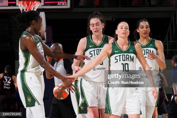 Tina Charles hi-fives Breanna Stewart and Sue Bird of the Seattle Storm during the game against the Indiana Fever on July 5, 2022 at Gainbridge...