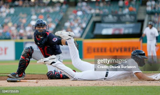 Riley Greene of the Detroit Tigers scores past catcher Luke Maile of the Cleveland Guardians on a single by Miguel Cabrera during the second inning...