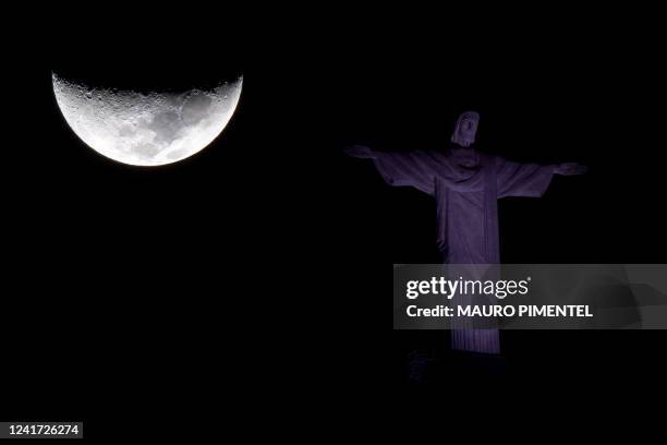 The waxing crescent moon and the Christ The Redeemer statue are seen in Rio de Janeiro, Brazil, on July 5, 2022.