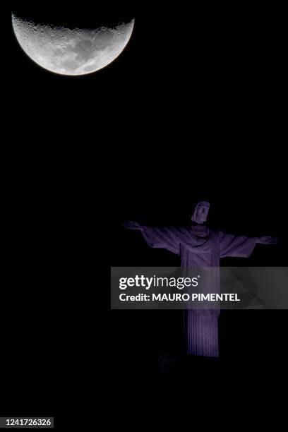 The waxing crescent moon and the Christ The Redeemer statue are seen in Rio de Janeiro, Brazil, on July 5, 2022.