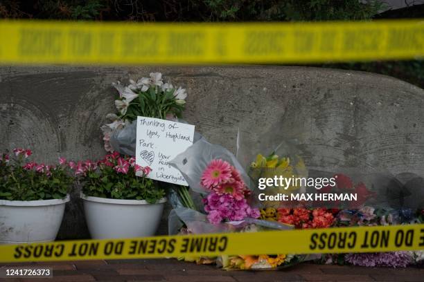 Flowers are left for victims of the 4th of July mass shooting in downtown Highland Park, Illinois on July 5, 2022. - The suspected gunman who opened...