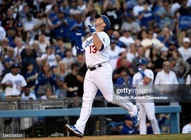 Max Muncy of the Los Angeles Dodgers celebrates his two-run home run against starting pitcher German Marquez of the Colorado Rockies in the second...