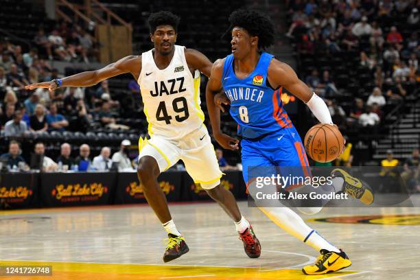 Jalen Williams of the Oklahoma City Thunder drives against Jeenathan Williams of the Utah Jazz during a NBA Summer League game at Vivint Arena on...