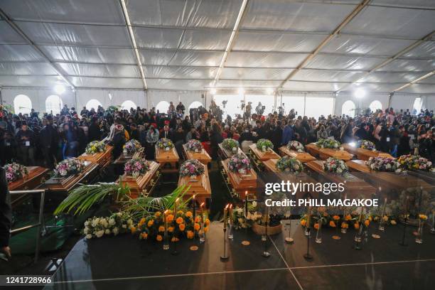 General view of empty coffins used in a symbolic mass memorial service in East London on July 6 after 21 people, mostly teens, died in unclear...