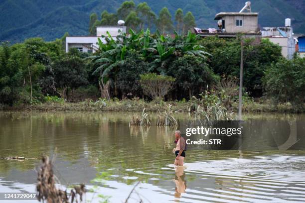 Resident walk through a flooded area after heavy rains caused by typhoon Chaba, in Yingde, Qingyuan city, in China's southern Guangdong province on...