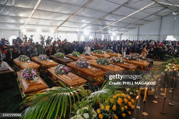 General view of empty coffins used in a symbolic mass memorial service in East London on July 6 after 21 people, mostly teens, died in unclear...