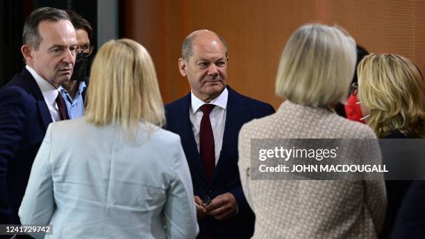 German Chancellor Olaf Scholz talks with the deputy spokeswoman of the government Christiane Hoffmann and German Minister for Transport and Digital...