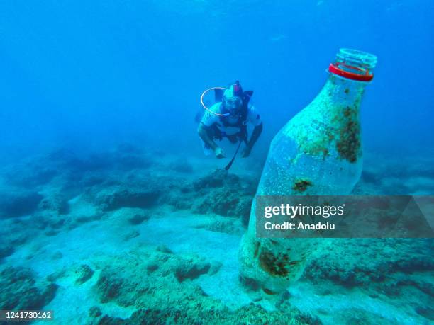 Team of volunteer divers collect various metal and plastic wastes with ghost nets that threaten marine life on the coast of Silifke district of...