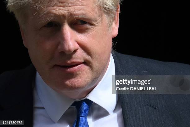 Britain's Prime Minister Boris Johnson walks to a waiting car as he leaves from 10 Downing Street in central London on July 6, 2022 to head to the...