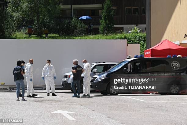 Carabinieri police officers of RIS stand next to a refrigerated container with the bodies of people who died under the Punta Rocca glacier avalanche...