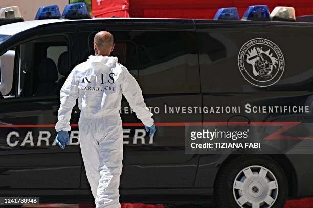 Carabinieri police officer of RIS walks near a refrigerated container with the bodies of people who died under the Punta Rocca glacier avalanche at...
