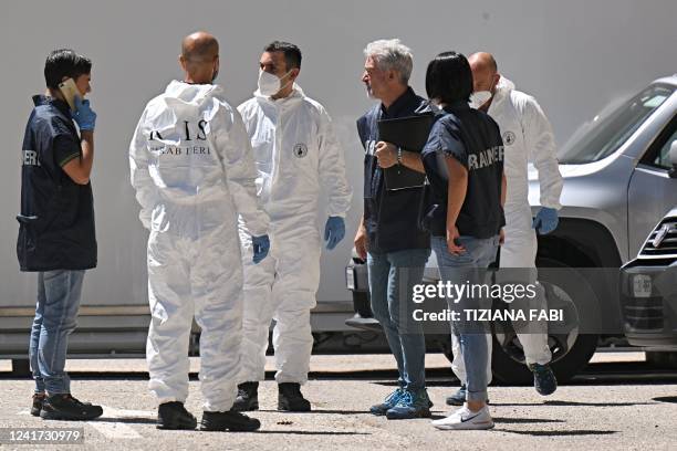 Carabinieri police officers of RIS stand next to a refrigerated container with the bodies of people who died under the Punta Rocca glacier avalanche...