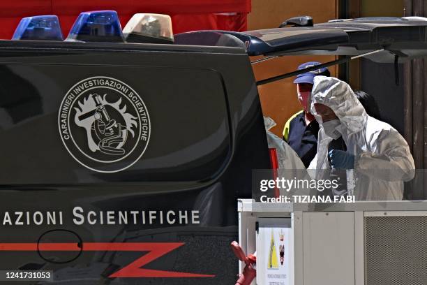 Carabinieri police officer of RIS work near a refrigerated container with the bodies of people who died under the Punta Rocca glacier avalanche at...