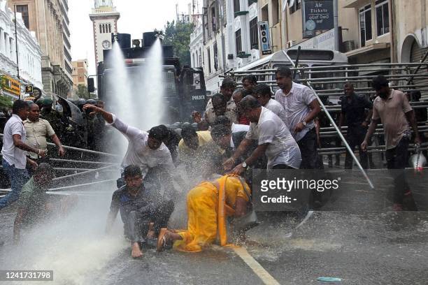 Police use water canon to disperse farmers taking part in an anti-government protest demanding the resignation of Sri Lanka's President Gotabaya...