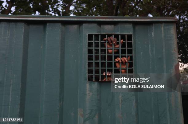 The hands of recaptured inmates are seen inside a prison vehicle in Abuja, Nigeria on July 6 after suspected Boko Haram gunmen attacked the Kuje...