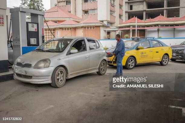 An employee fills a car at fuel station in Addis Ababa, Ethiopia, on July 6, 2022. Fuel prices soared in Ethiopia on July 6, 2022 after the...