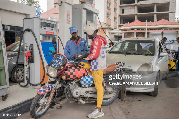 Motorcyclist makes a payment at a fuel station in Addis Ababa, Ethiopia, on July 6, 2022. Fuel prices soared in Ethiopia on July 6, 2022 after the...
