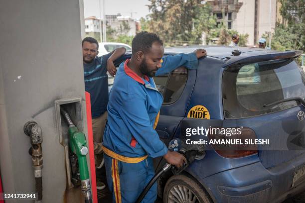 An employee fills a car at a fuel station in Addis Ababa, Ethiopia, on July 6, 2022. Fuel prices soared in Ethiopia on July 6, 2022 after the...