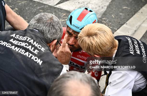 Lotto Soudal team's Australian rider Caleb Ewan reacts to medical staff after suffering a crash during the 5th stage of the 109th edition of the Tour...
