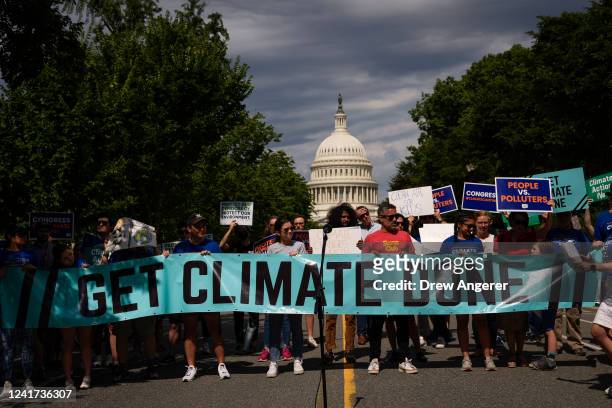 Environmental activists rally near the U.S. Capitol on July 6, 2022 in Washington, DC. The group Climate Action Campaign organized the rally to...