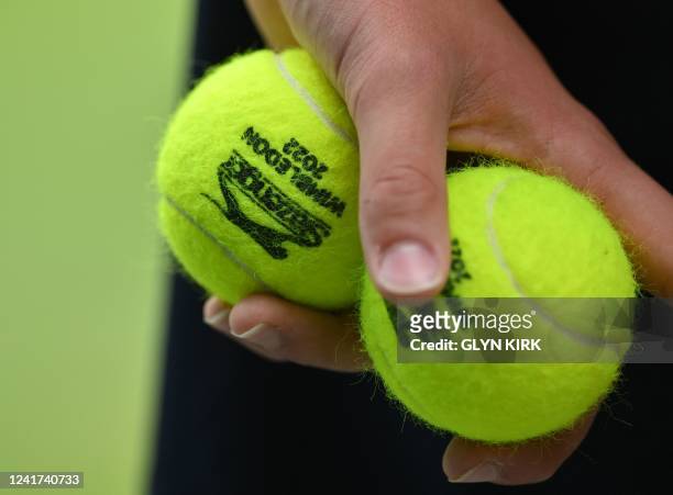 Ball boy holds two tennis balls during the men's singles quarter final tennis match between Spain's Rafael Nadal and US player Taylor Fritz on the...