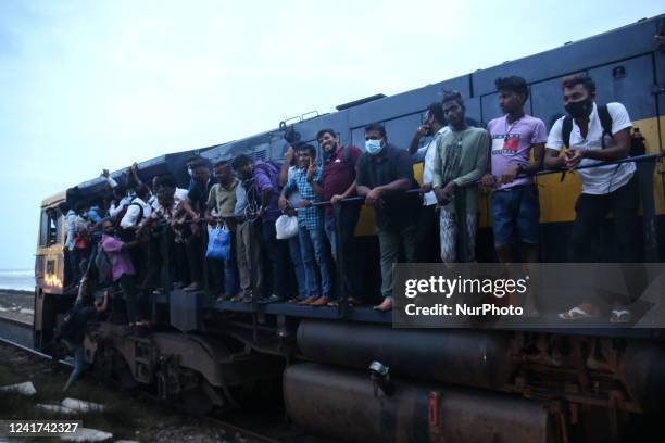 Passengers board the engine compartment of an overcrowded train in Colombo, Sri Lanka. On July 6, 2022. Other public transport in Sri Lanka has been...