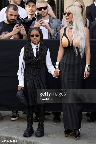 Socialite Kim Kardashian and her daughter North West arrive to attend the collection show for Jean-Paul Gaultier during the Women's Haute-Couture...