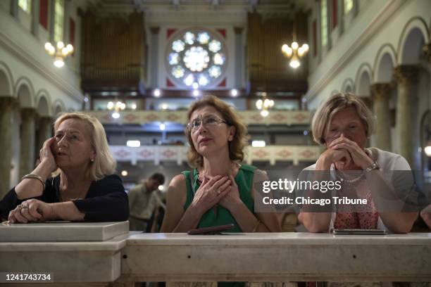 From left, Jadzia , Lucy Smagacz and Barbara Radlinska attend Mass at Chicago&apos;s St. Adalbert&apos;s Catholic Church in July 2019. In a new...