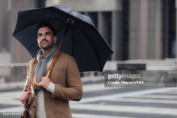 ik vraag me af hoe morgen eruit zal zien? - man with umbrella stockfoto's en -beelden