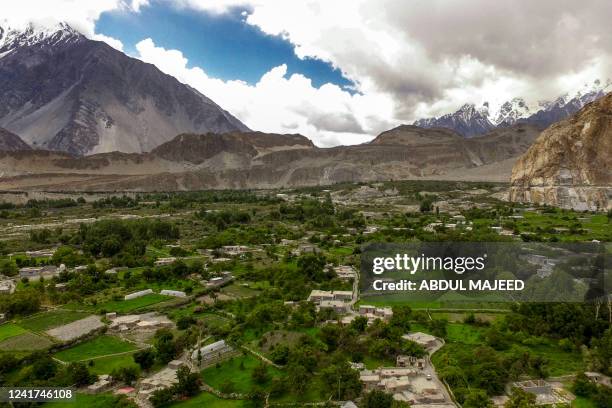 This aerial picture taken on June 10 shows Passu village, which is under threat from land erosions caused by glacial lake outbursts, in Pakistan's...