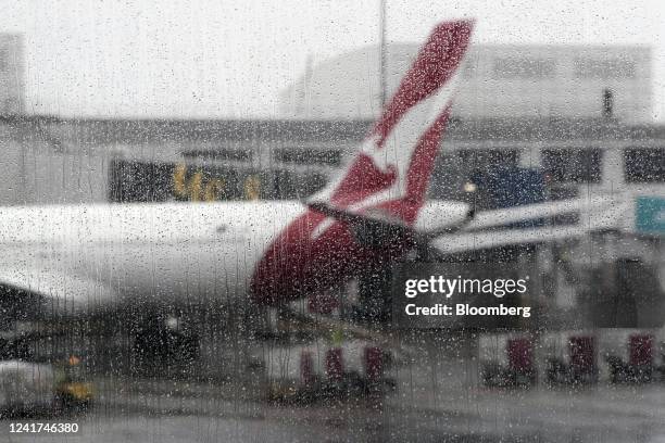 Rain droplets on a window near a Qantas Airways Ltd. Aircraft on the tarmac at Sydney Airport in Sydney, Australia, on Wednesday, July 6, 2022....
