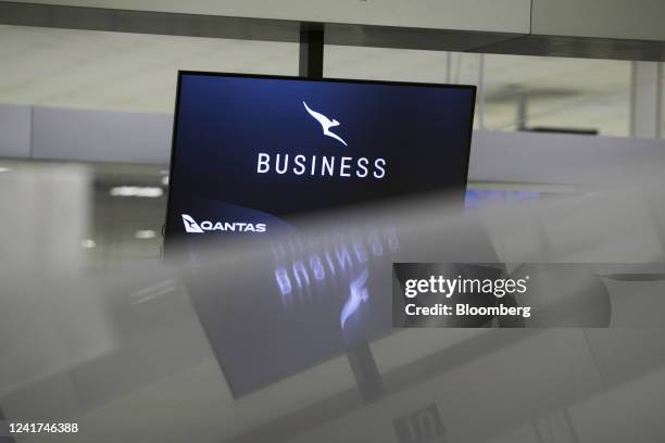 Qantas Airways Ltd. Business class check-in screen reflected on a surface at Sydney Airport in Sydney, Australia, on Wednesday, July 6, 2022. Qantas,...