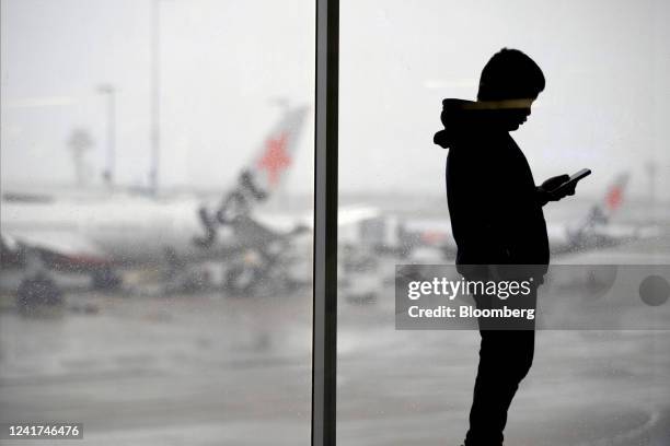 Passenger near aircraft operated by Qantas Airways Ltd.'s low-cost unit Jetstar Airways on the tarmac at Sydney Airport in Sydney, Australia, on...