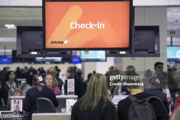 Passengers check-in for a flight operated by Qantas Airways Ltd.'s low-cost unit Jetstar Airways at Sydney Airport in Sydney, Australia, on...