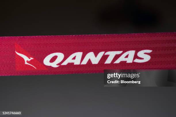 Qantas Airways Ltd. Branding on a barrier tape at the company's check-in counter at Sydney Airport in Sydney, Australia, on Wednesday, July 6, 2022....