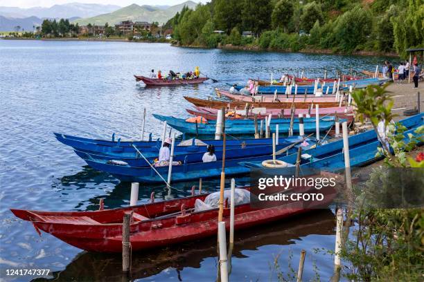 Cruise ships dock at the bank of Lugu Lake in Lijiang, Yunnan Province, China, July 7, 2022. Lugu Lake, known as the "Pearl of the Plateau", is 2,690...