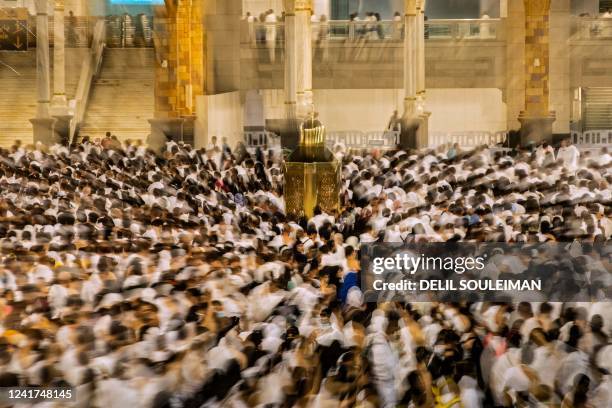 Muslim pilgrims converge on the Maqam Ibrahim as they pray near the Kaaba, Islam's holiest shrine, at the Grand Mosque in Saudi Arabia's holy city of...