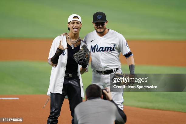 Rap artist Robi poses with Miami Marlins shortstop Miguel Rojas after throwing out the first pitch prior to the MLB game against the Los Angeles...