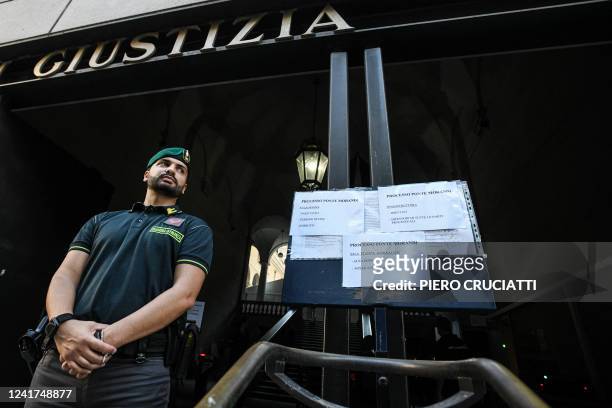 Guardia di Finanza officer stands guard outside the Genoa courthouse ahead of the first hearing of the Morandi bridge collapse trial in Genoa, on 7...