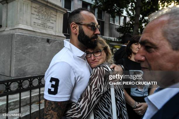 Family members of victims react as they gather outside the Genoa courthouse ahead of the first hearing of the Morandi bridge collapse trial in Genoa,...