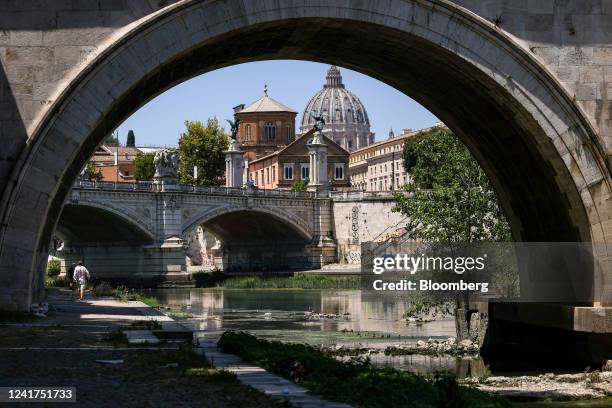 Resurfaced rocks in the River Tiber, following unusually hot weather and low rainfall, in view of St. Peters dome in Rome, Italy, on Wednesday, July...