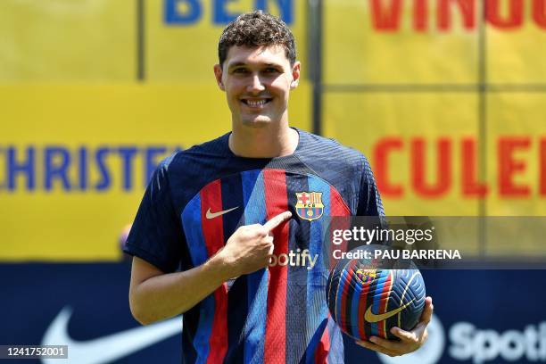 Barcelona's new Danish defender Andreas Christensen poses for pictures with his new jersey during his presentation ceremony at the Joan Gamper...