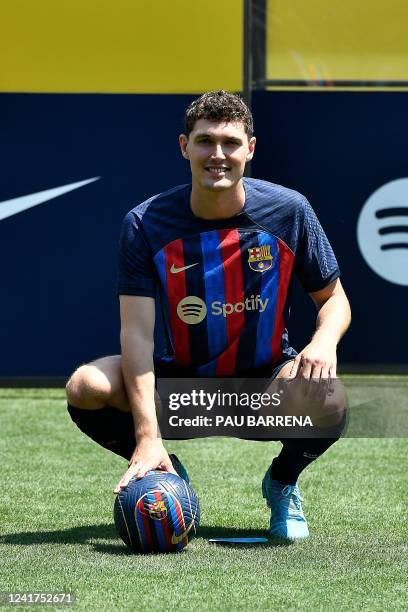 Barcelona's new Danish defender Andreas Christensen poses for pictures with his new jersey during his presentation ceremony at the Joan Gamper...