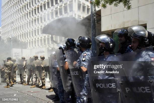 Lebanese forces take security measures in the demonstration area as people, whose bank deposits have been frozen for two years by the government,...