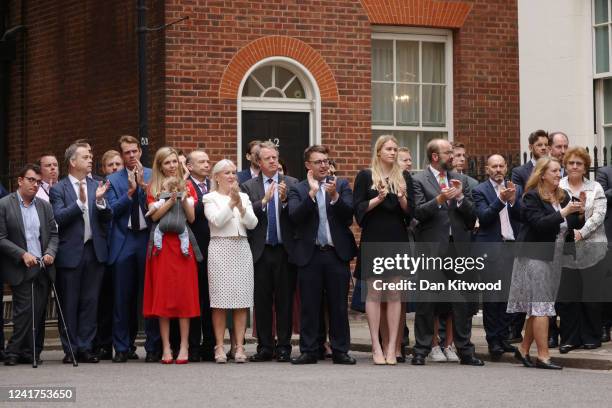 Onlookers, including Carrie Johnson, and baby Romy, Culture Secretary Nadine Dorries , Scotland Secretary Alister Jack and Charlotte Owen, an aide to...